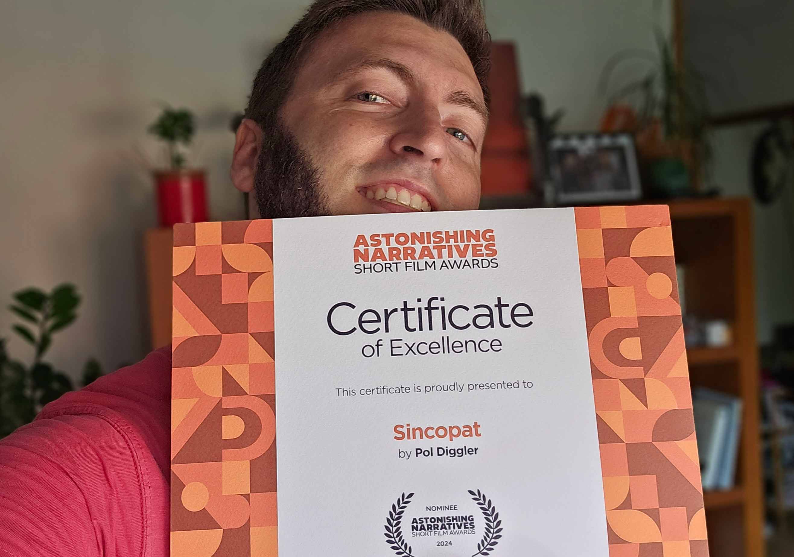 picture of filmmaker holding a certificate